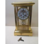 A good four glass gilt brass mantle clock with exposed escapement and mercury pendulum, striking