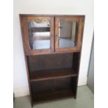 A small oak bookcase with cupboard, 92cm tall x 51cm x 15cm