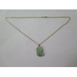 A gilt metal mounted jade pendant on a 14ct yellow gold chain, 48cm long, total weight approx 9