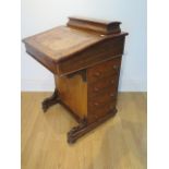 A Victorian inlaid walnut 4 drawer Davenport desk in need of restoration missing back foot, 81cm