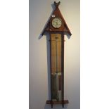 An oak Admiral Fitzroy barometer with clock and thermometer, 130cm tall, clock not currently