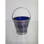 A George III silver pierced cream pail with blue glass liner, London 1816/17 PF, 6.5cm tall with