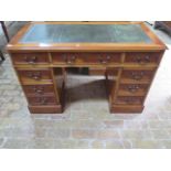 A modern yew wood veneer 8 drawer twin pedestal desk, 77cm tall x 121cm x 60cm