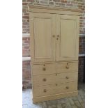 A 19th century stripped pine linen press / cupboard on chest with a 2 door top enclosing two shelves