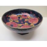 A Moorcroft fruit bowl on a later wooden stand, 12cm tall x 24cm diameter, overall crazing but not