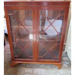 A modern yew wood 2 door glazed bookcase / display cabinet, 110cm tall x 84cm x 33xm