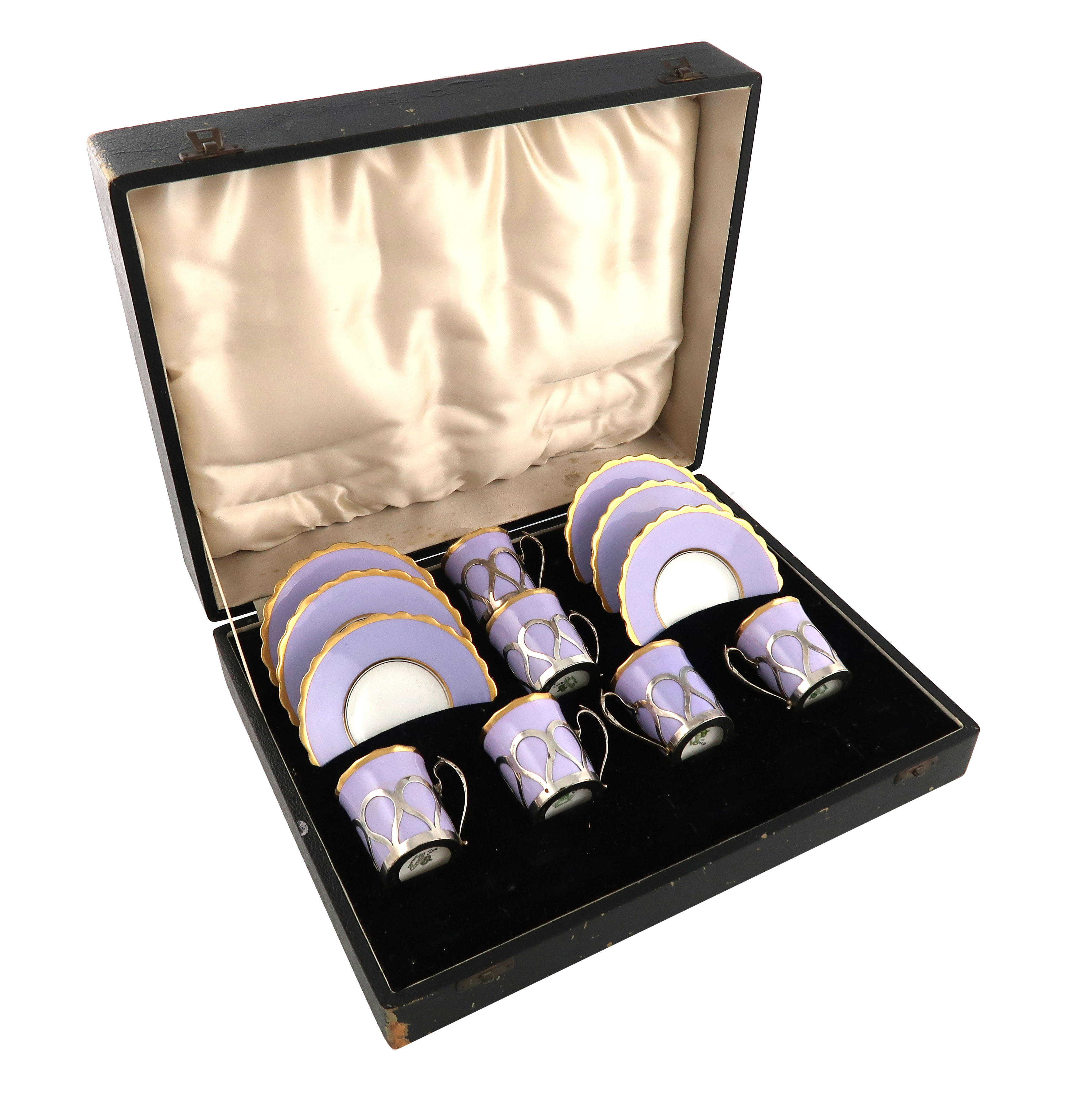 A set of six silver-mounted ceramic coffee cups and saucers, the mounts by James Dixon and Sons,