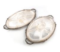 A matched pair of silver two handle hors d'oeuvres trays, by Harrods (Richard Woodman Burbridge),