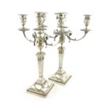 A pair of late Victorian silver three-light candelabra, by Walker & Hall, Sheffield,1898, in