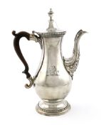 A George III silver coffee pot, by Daniel Smith and Robert Sharp, London 1776, baluster form, wooden