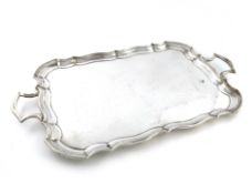 A silver two-handled tray, maker's mark worn, Birmingham 1930, shaped rectangular form, moulded