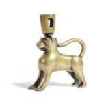 A BRONZE CANDLESTICK IN THE FORM OF A LION OR LEOPARD POSSIBLY DINANT, IN 14TH CENTURY STYLE with