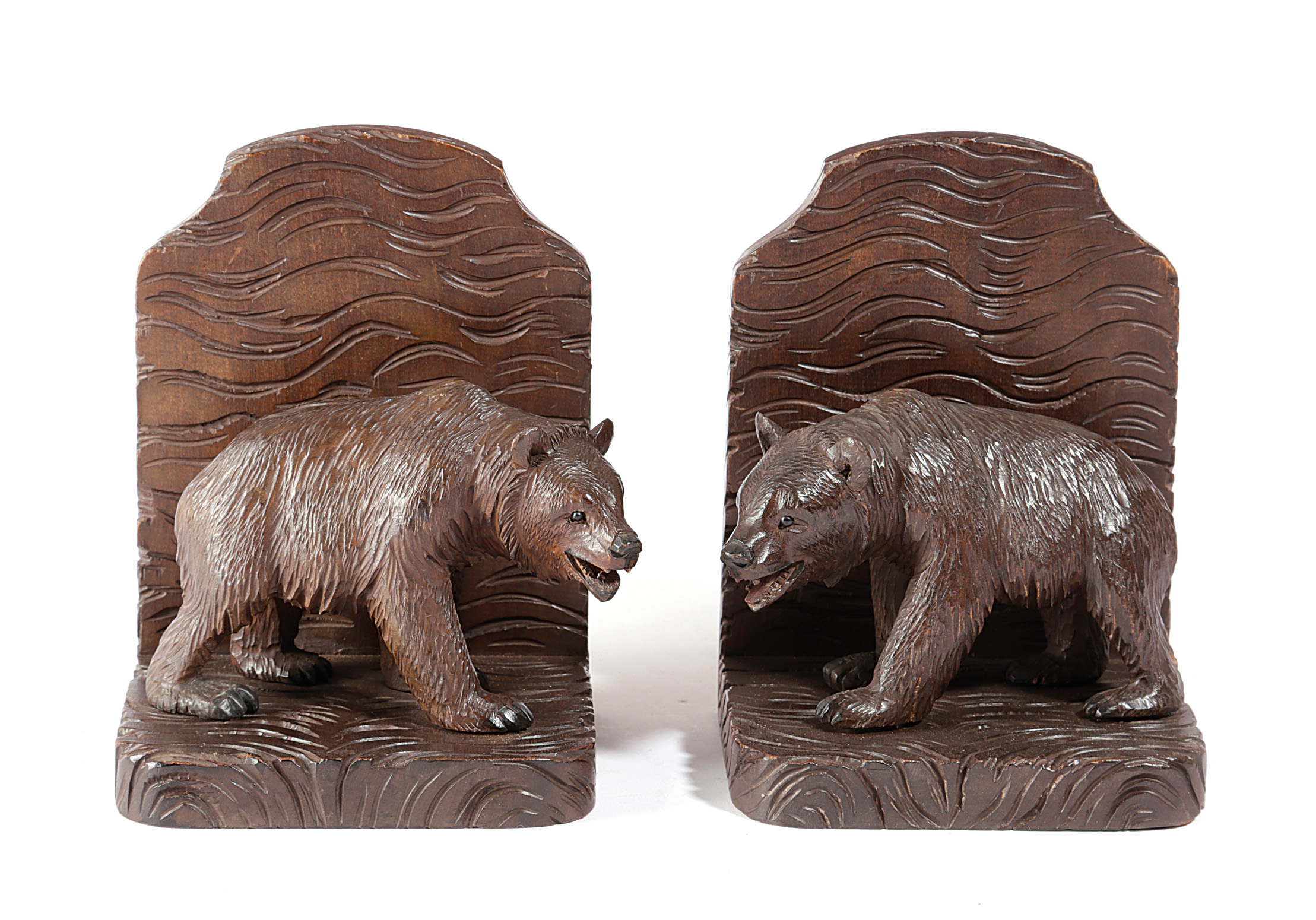 A PAIR OF BLACK FOREST LINDEN WOOD BEAR BOOKENDS FIRST HALF 20TH CENTURY each modelled with a