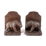 A PAIR OF BLACK FOREST LINDEN WOOD BEAR BOOKENDS FIRST HALF 20TH CENTURY each modelled with a