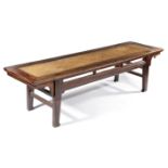 A CHINESE ELM BENCH LATE 18TH / EARLY 19TH CENTURY the rectangular top inset with a rattan panel,