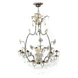 A FRENCH GILT AND EBONISED METAL TWELVE-LIGHT CHANDELIER IN THE MANNER OF MAISON JANSEN, C.1940 of