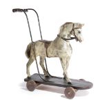 A CARVED AND PAINTED PINE CHILD'S PULL-ALONG TOY HORSE LATE 19TH / EARLY 20TH CENTURY with leather