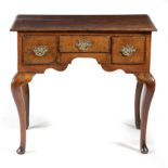 A GEORGE II OAK LOWBOY MID-18TH CENTURY with three frieze drawers, on cabriole legs and pad feet