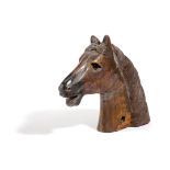 A CARVED AND PAINTED WOOD HORSE'S HEAD with glass eyes 25cm high, 30cm long