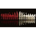 λ A CHINESE EXPORT CARVED IVORY FIGURAL CHESS SET MID-19TH CENTURY natural and stained red, the