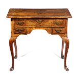 A GEORGE II WALNUT LOWBOY C.1725-30 the quarter veneered cross and feather banded top with a moulded