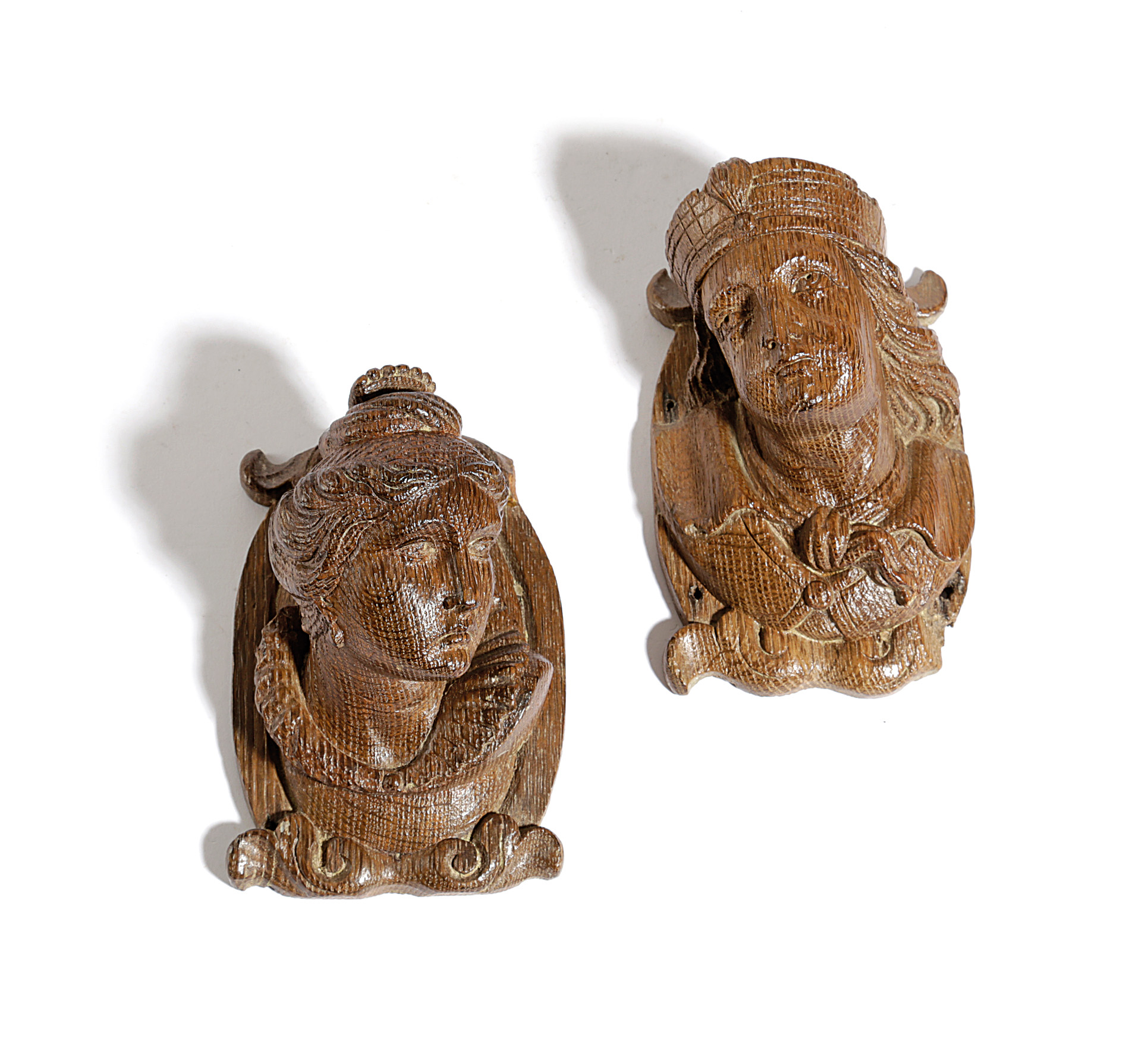 A PAIR OF CONTINENTAL OAK ARCHITECTURAL FRAGMENT BUSTS 17TH / 18TH CENTURY of a Queen and a young