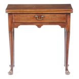 A GEORGE II MAHOGANY TEA TABLE C.1740 the fold-over top on a single gate support, fitted with a