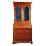 A GEORGE II BURR WALNUT BUREAU BOOKCASE C.1730 with a pair of doors with later bevelled arched