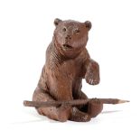 A BLACK FOREST LINDEN WOOD BEAR PEN HOLDER LATE 19TH / EARLY 20TH CENTURY the seated bear with glass