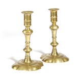 A PAIR OF GEORGE II BRASS CANDLESTICKS C.1740-1760 each of seamed construction and with a knopped