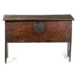 A CHARLES II OAK COFFER C.1660 of five plank construction, the hinged lid with a thumbnail carved