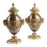 A PAIR OF GILT AND PATINATED BRONZE URNS IN LOUSI XVI STYLE LATE 19TH / EARLY 20TH CENTURY each with