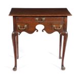 A GEORGE II OAK LOWBOY C.1740 the top with a caddy moulded edge, above three frieze drawers and a