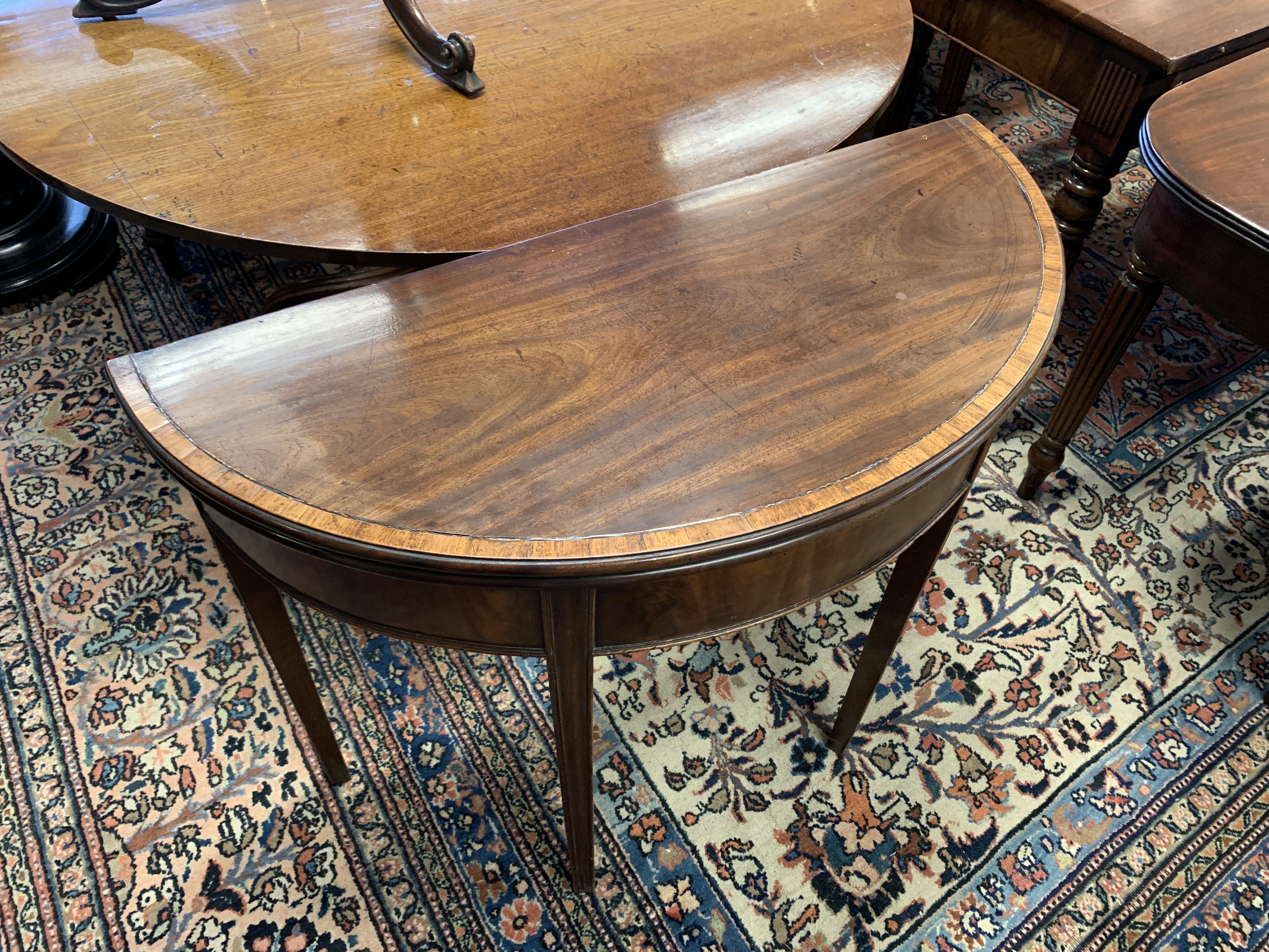 A GEORGE III MAHOGANY DEMI-LUNE TEA TABLE LATE 18TH CENTURY with a crossbanded top on moulded legs - Image 2 of 8