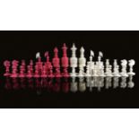 AN INDIAN CARVED AND TURNED BONE CHESS SET 19TH CENTURY natural and stained red (32) the king: 13.