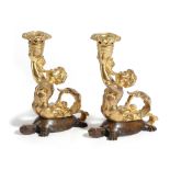 A PAIR OF GILT AND PATINATED BRONZE TRITON CANDLESTICKS 19TH CENTURY each modelled with the sea