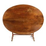 A FRENCH WALNUT VENDANGE OR WINE TASTING TABLE 19TH CENTURY the oval tilt-top with a reeded edge