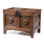 A SMALL OAK COFFER MID-17TH CENTURY the hinged lid revealing a vacant interior, the twin panel front