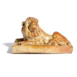 A BROWN STONEWARE SALTGLAZED POTTERY MODEL OF A RECUMBENT LION C.1840