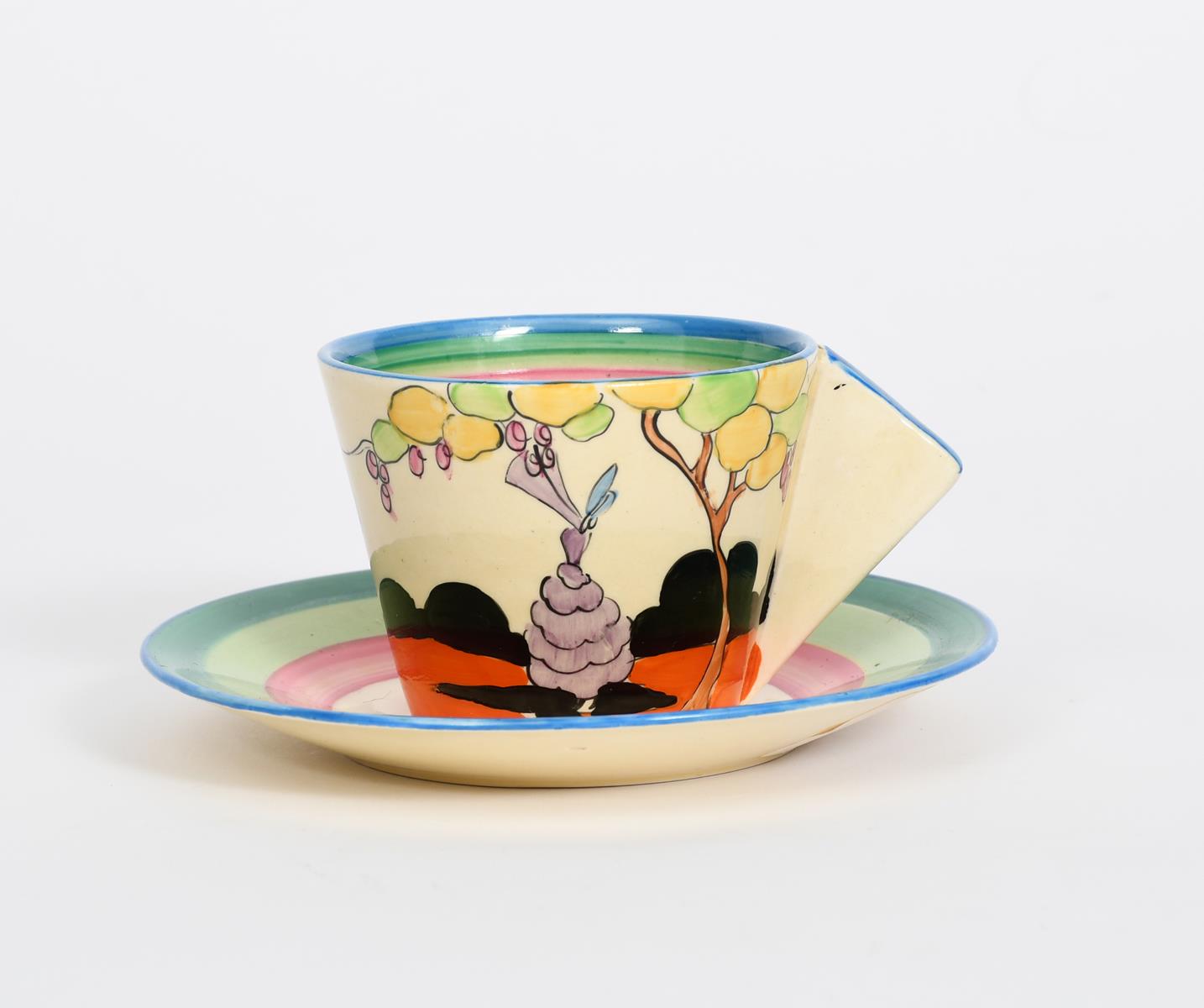 'Idyll' a Clarice Cliff Bizarre Conical coffee cup and saucer, painted in colours between pink,