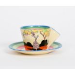 'Idyll' a Clarice Cliff Bizarre Conical coffee cup and saucer, painted in colours between pink,