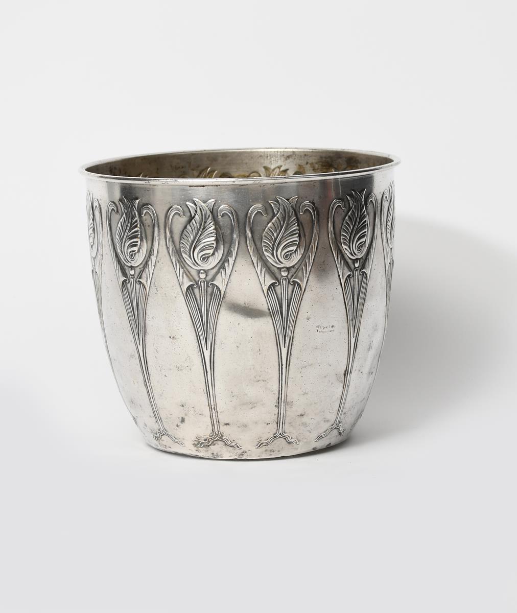 An Art Nouveau Dutch KMD Tiel pewter planter, flaring cylindrical form, cast in low relief with