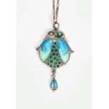 An Art Nouveau James Fenton silver and enamel pendant, cast as a simple flower form, enamelled in