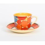 'Berries' a Clarice Cliff Fantasque Bizarre tea cup and saucer, painted in colours, the saucer