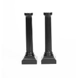 A pair of Linley ebonised wood and polished metal candlesticks designed by David Linley, each