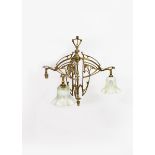 An Art Nouveau brass three light ceiling light, cast and pierced with stylised whiplash berried