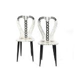 A pair of Fornasetti Studios Lyre chairs designed by Piero Fornasetti, printed in black and white,