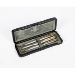 A Parker 75 silver aerometric fountain pen pencil and ball pen set, each textured with gilt clip and
