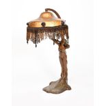 An Art Nouveau patinated metal table lamp, the base cast with a maiden standing above stylised