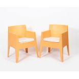 A pair of Dryiad Toy armchairs designed by Phillipe Starck, orange moulded polypropylene, with white